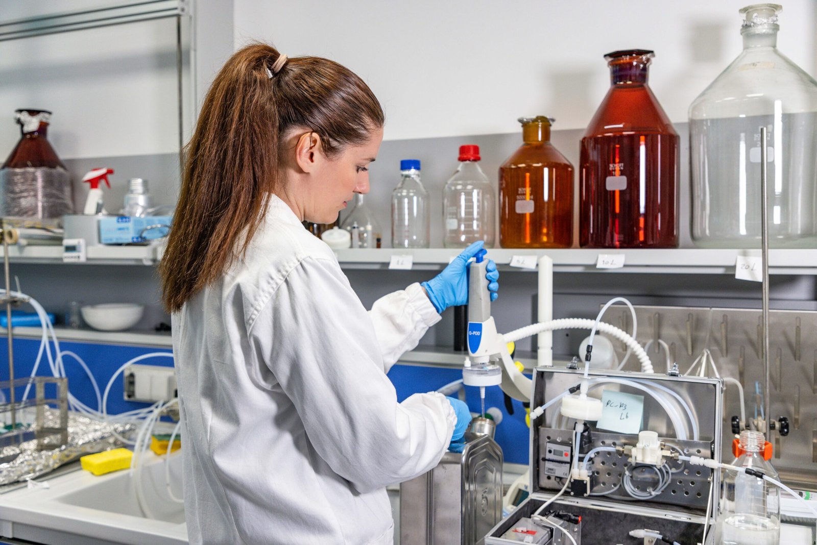 Laboratory technician performing water quality testing with lab equipment in a modern testing laboratory